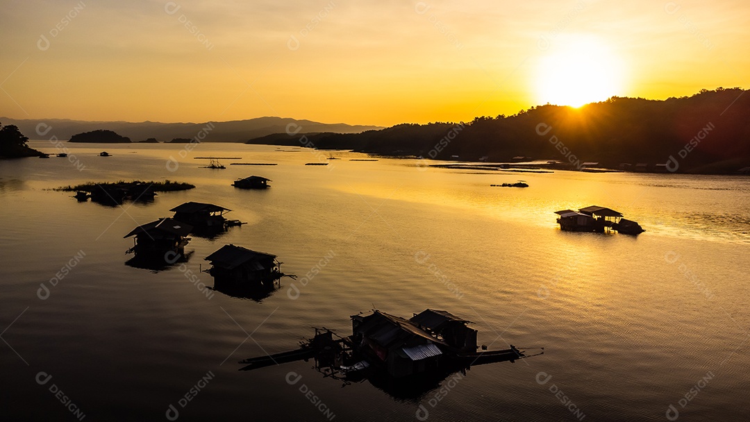 Vista aérea do pôr do sol da paisagem com reservatório e casa de jangada