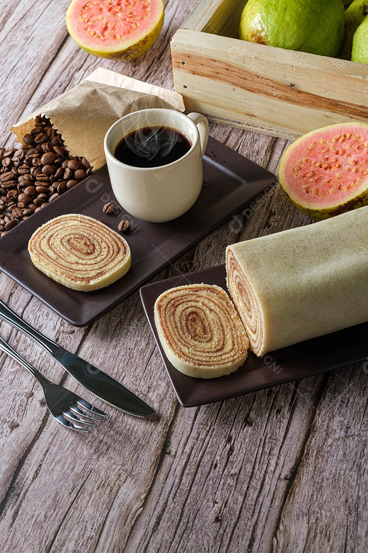 Fatia de Bolo de Rolo Rodeada de Goiabada, Xícara e Grãos de Café