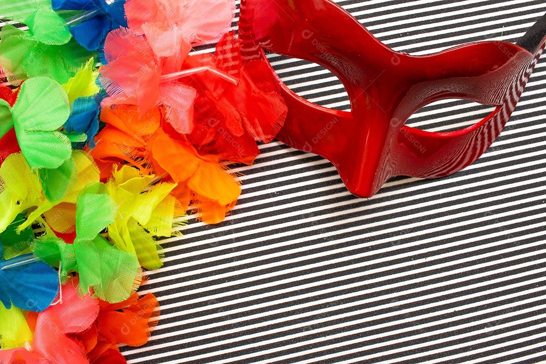 máscara de carnaval vermelha em um fundo listrado preto e branco