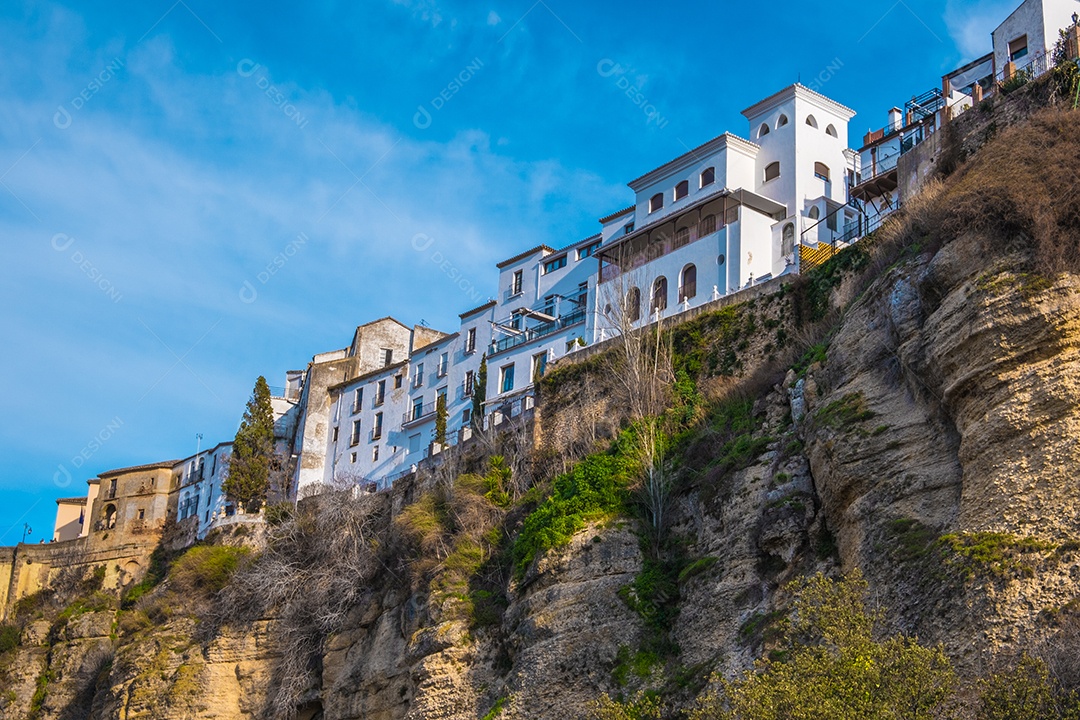 Casas construídas à beira de um penhasco contra céu azul