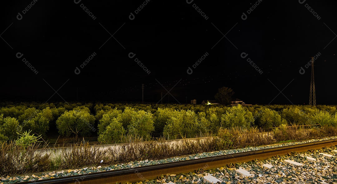 Vista dos trilhos da estação ferroviária de Ronda à noite.