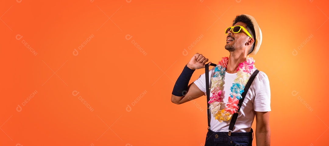 Traje Brasileiro de Carnaval. Homem negro com fantasia de carnaval se divertindo, isolado em fundo laranja