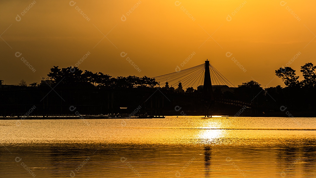 O pôr do sol quase cai do céu no horizonte refletido na água