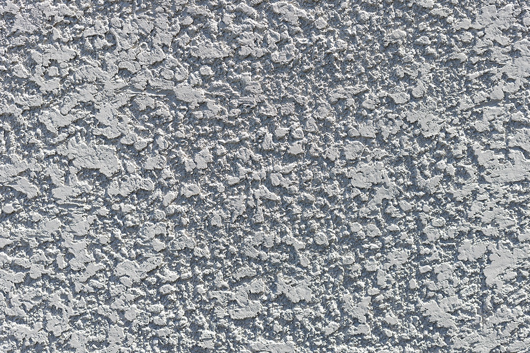 Parede cinza texturizada de cimento áspero salpicado