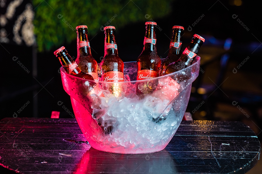 Balde de cerveja gelada budweiser sobre uma mesa de bar