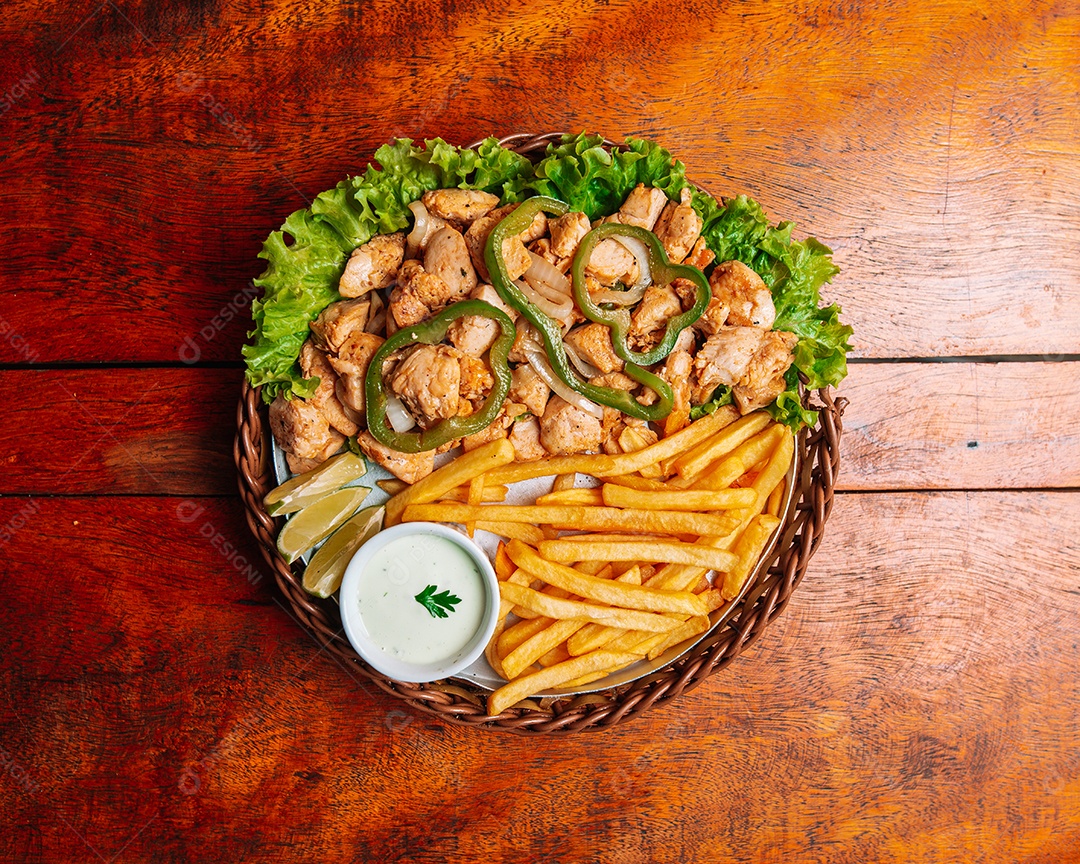 Porção de fritas com batata frita sobre uma mesa de madeira