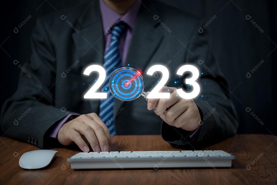 empresário segurando lupa para 2023 para preparação conceito feliz ano novo. novos negócios em novos anos, start up, plano de ação e estratégia em novos negócios.