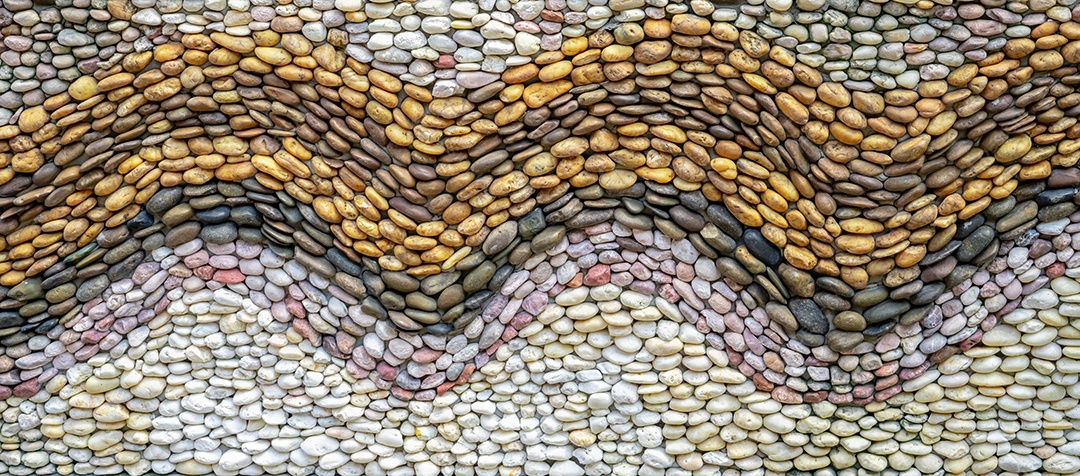 Fundo de textura de parede de pedra de seixos. Mosaico de seixos.