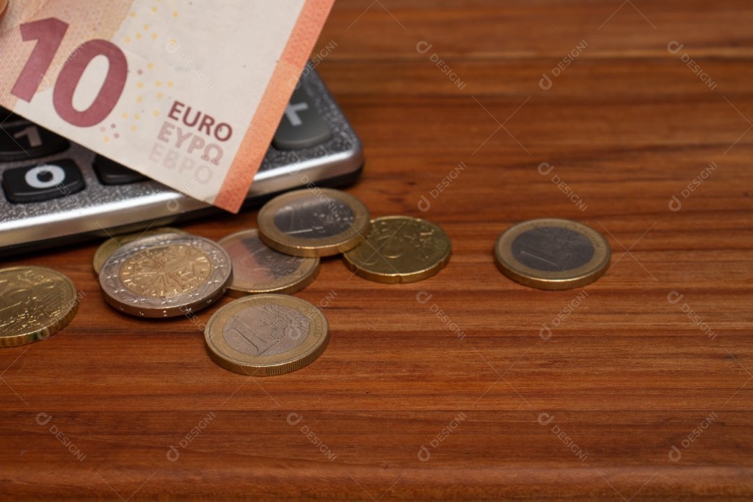 Dinheiro ao lado de calculadora sobre uma mesa