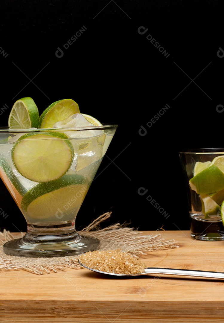 Bebida brasileira caipirinha com limão e ingredientes ao redor