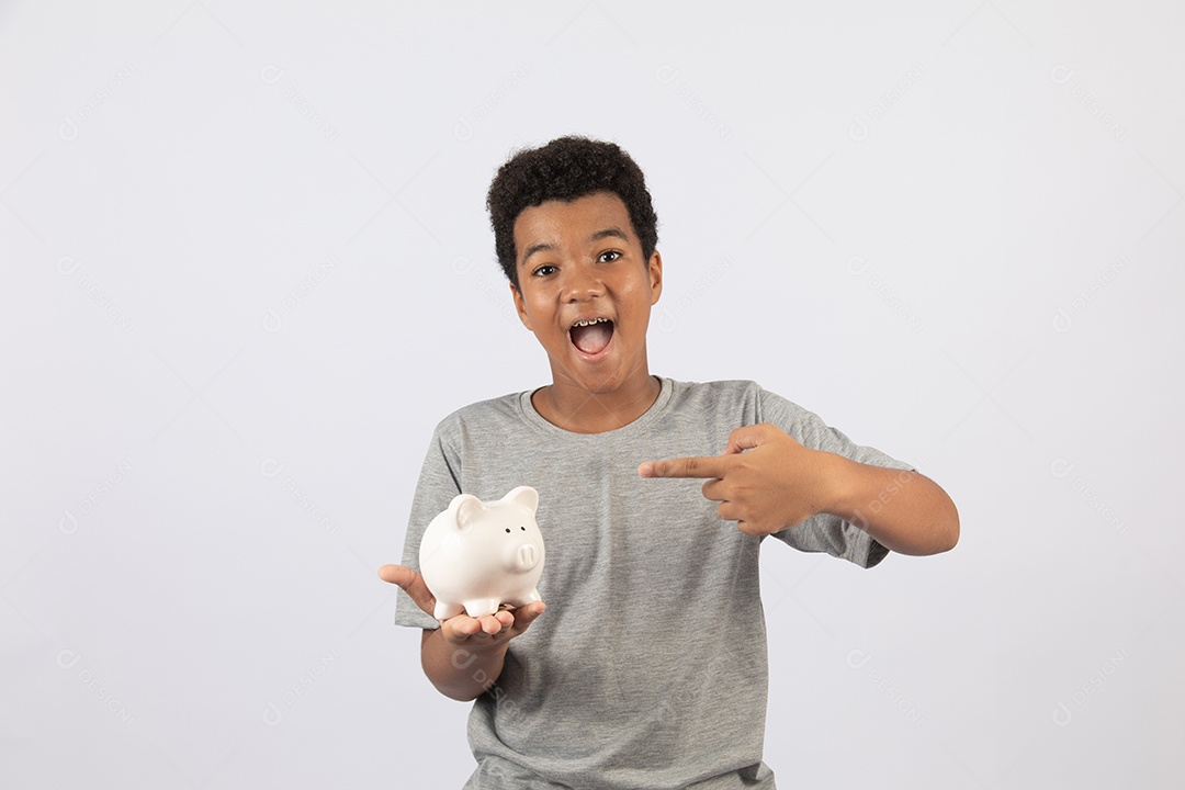 Menino jovem segurando cofrinho sobre fundo isolado