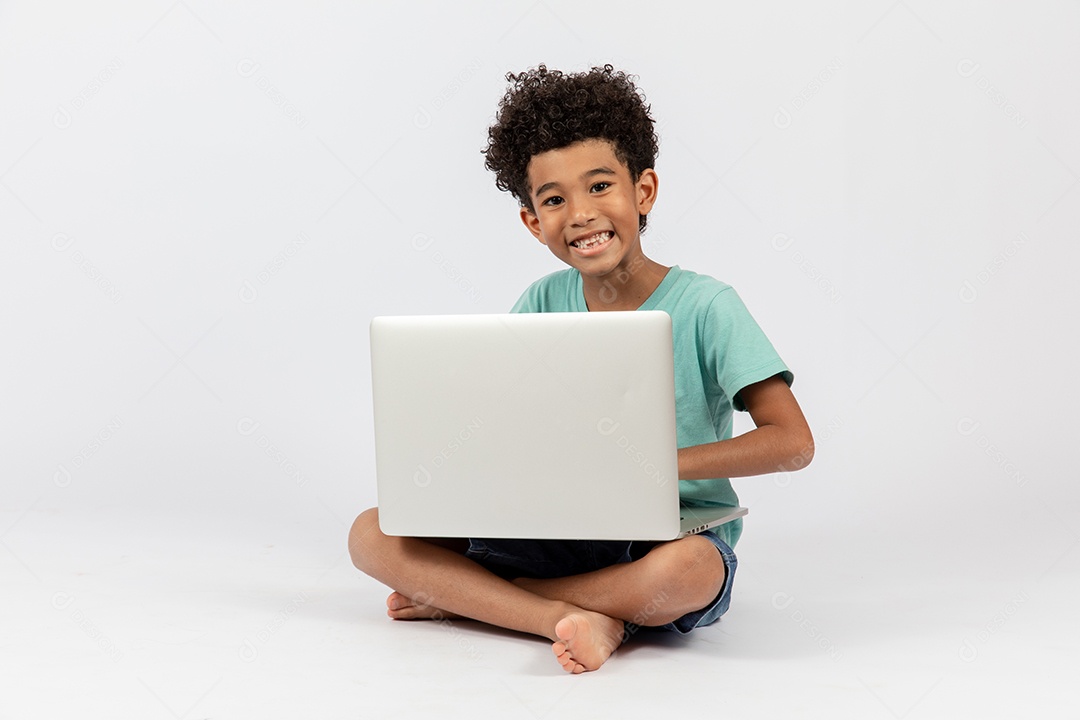 Menino jovem mexendo em seu notebook sobre fundo isolado