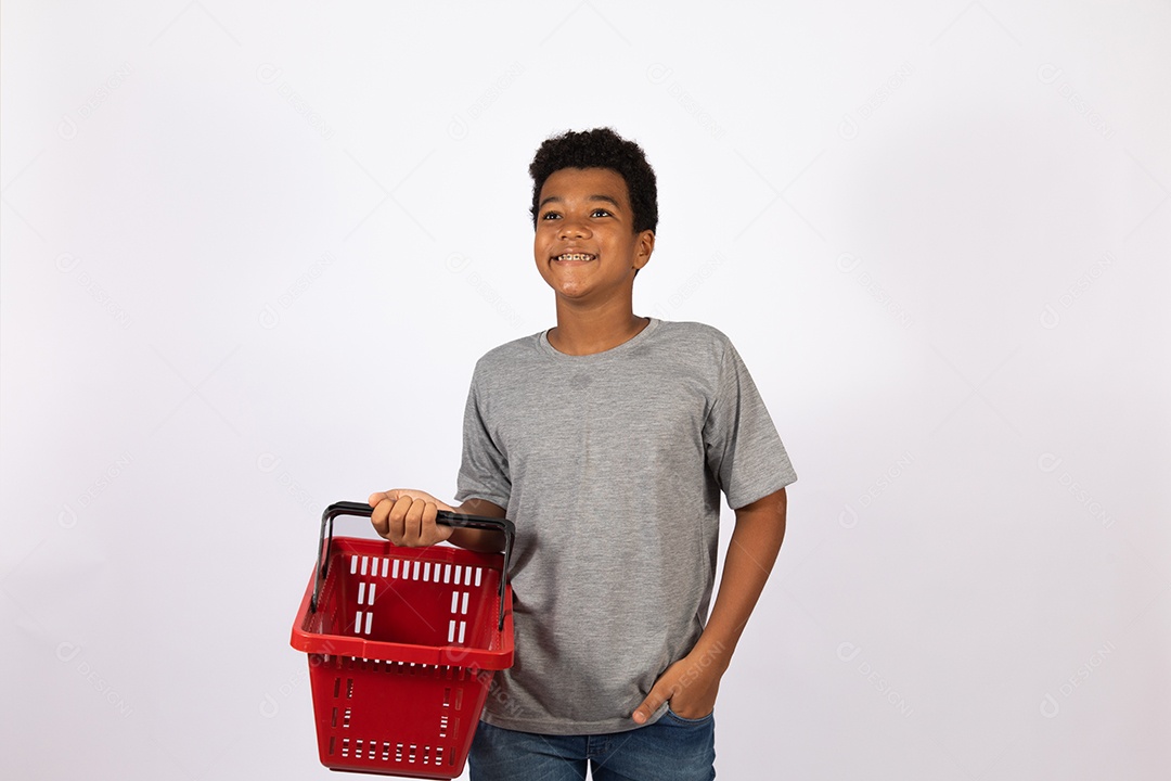 Menino jovem segurando cesta de mercado supermercado sobre fundo isolado