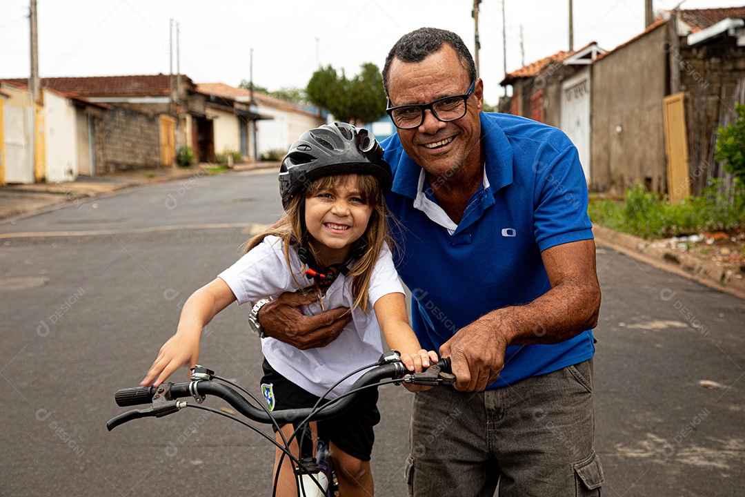 Pai ensinado sua filha a andar de bicicleta