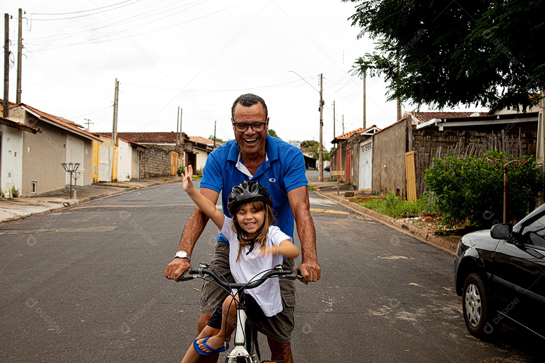 Pai ensinado sua filha a andar de bicicleta