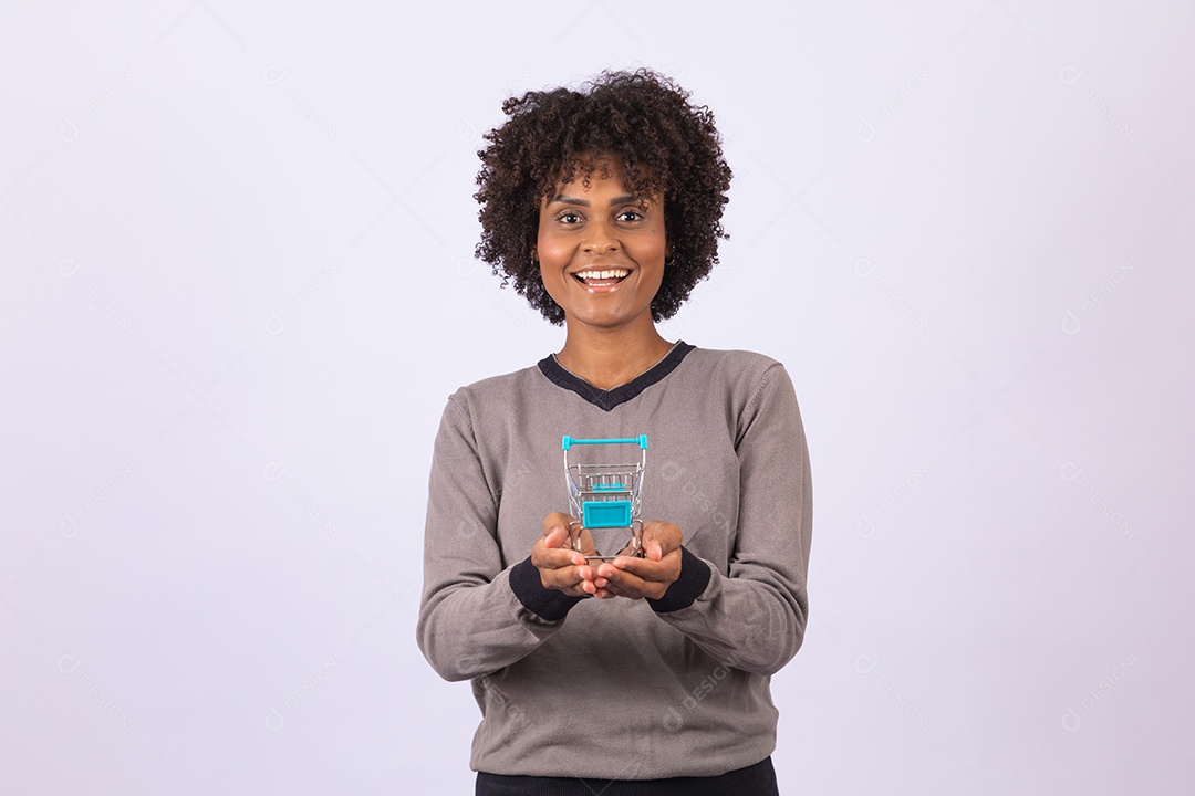 Linda mulher garota jovem cabelo afro segurando carrinho de compras
