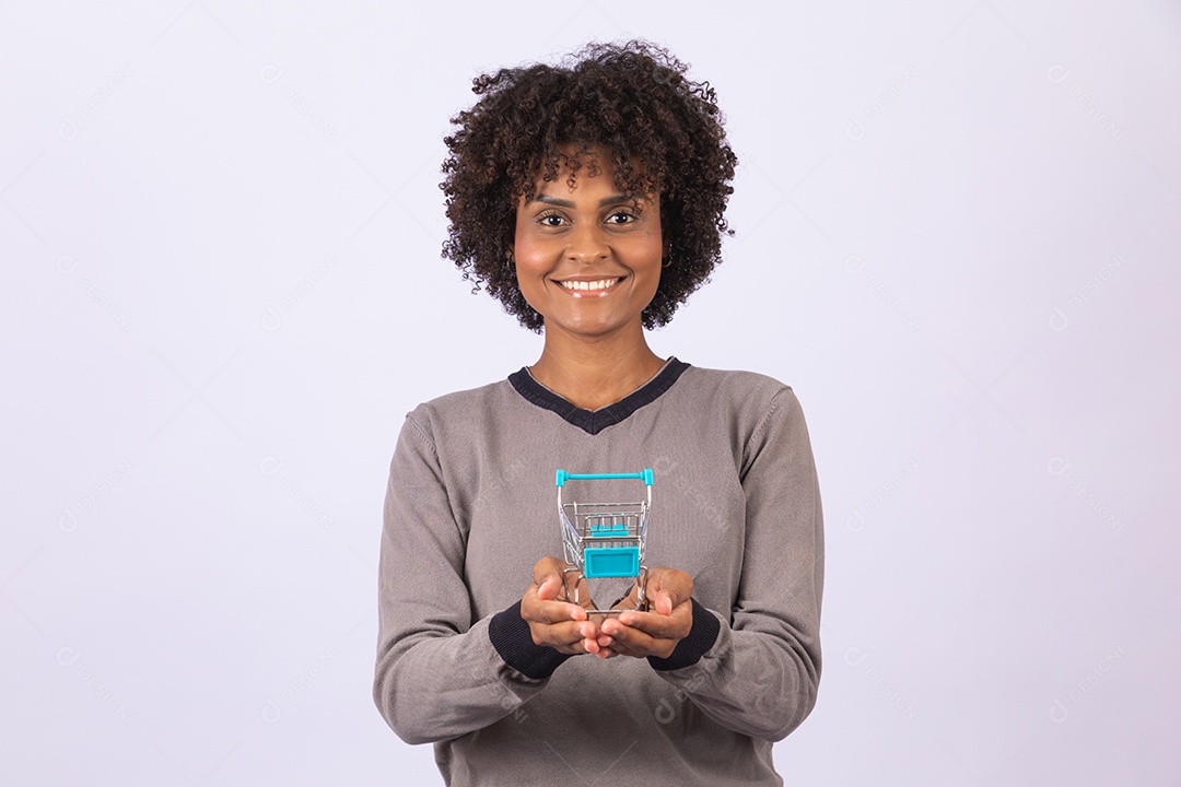 Linda mulher garota jovem cabelo afro segurando carrinho de compras