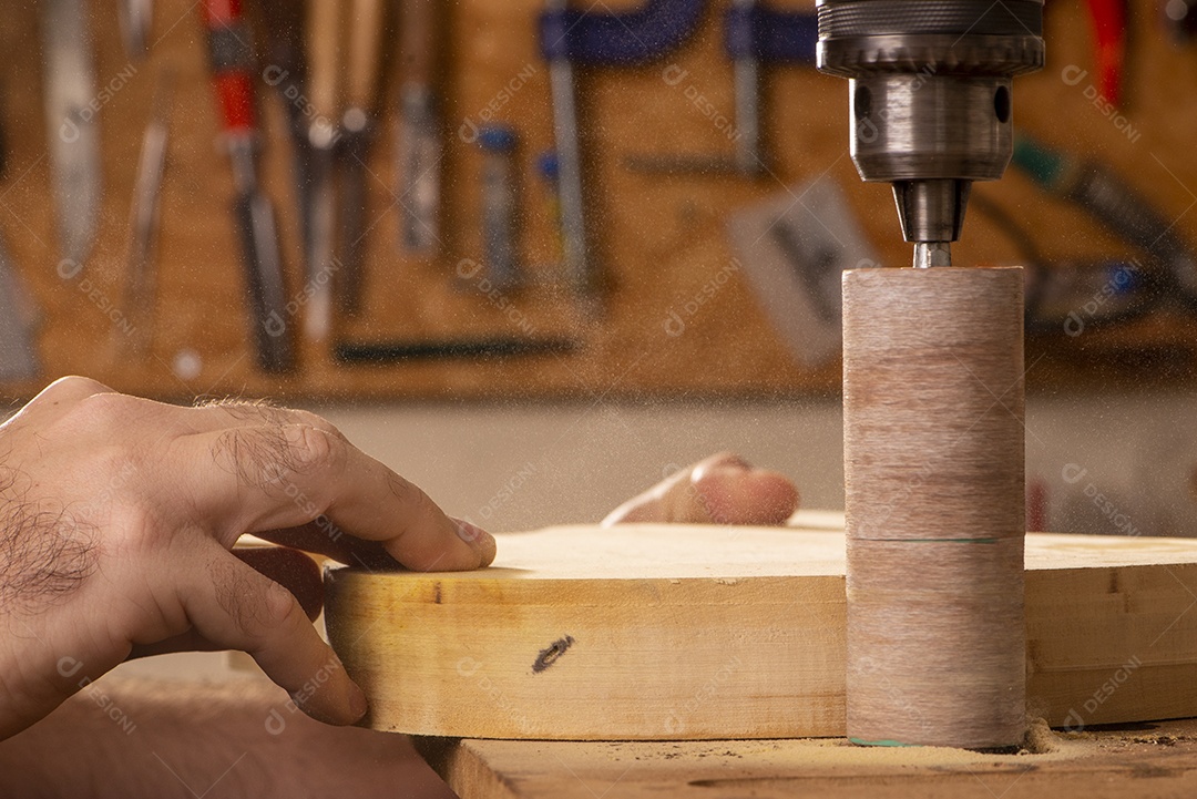 Luthier lixando corpo de violão