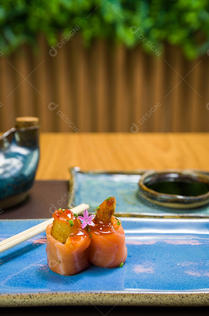 Combinado de diferentes sushis japoneses em um elegante prato azul.