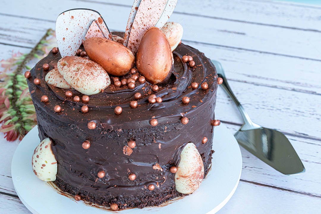 Bolo de chocolate decorado com ovos de páscoa de chocolate branco