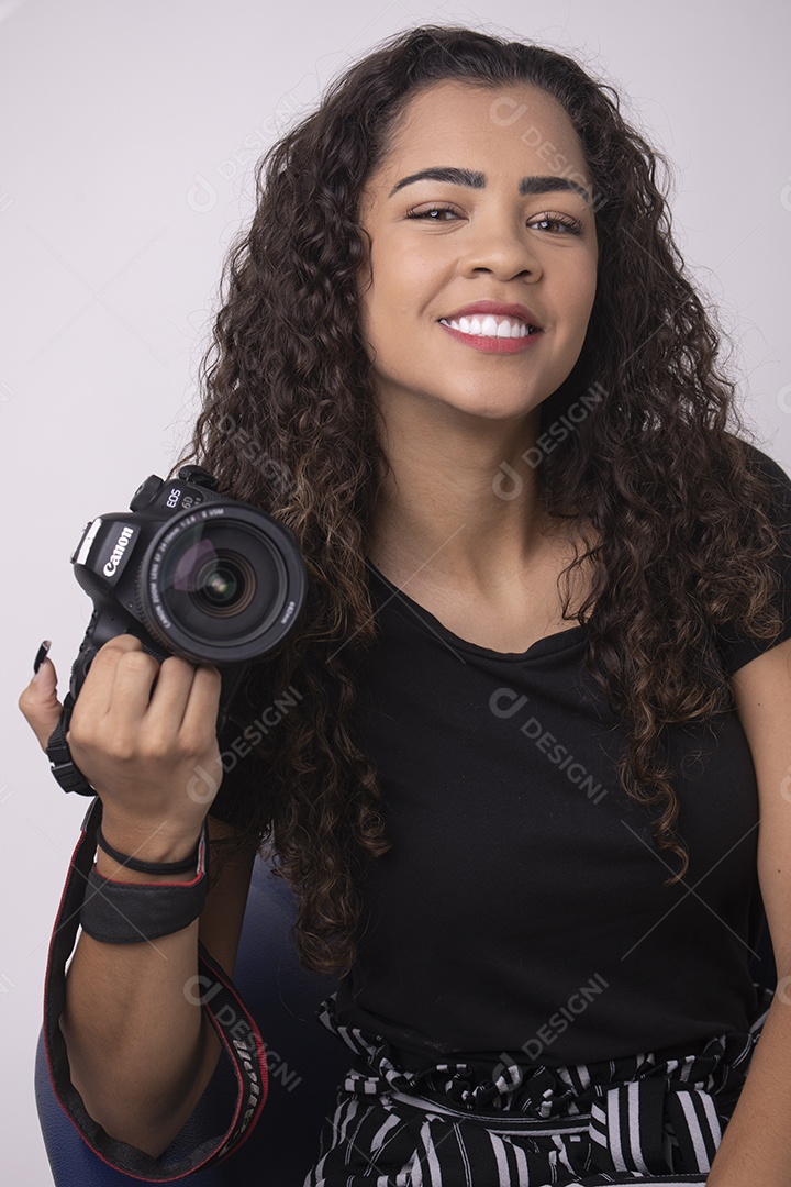 Linda mulher garota jovem segurando câmera fotográfica sobre fundo isolado