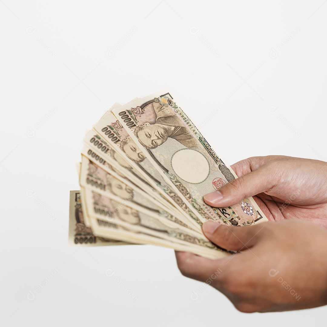 Mão de homem segurando a pilha de notas de iene japonês.