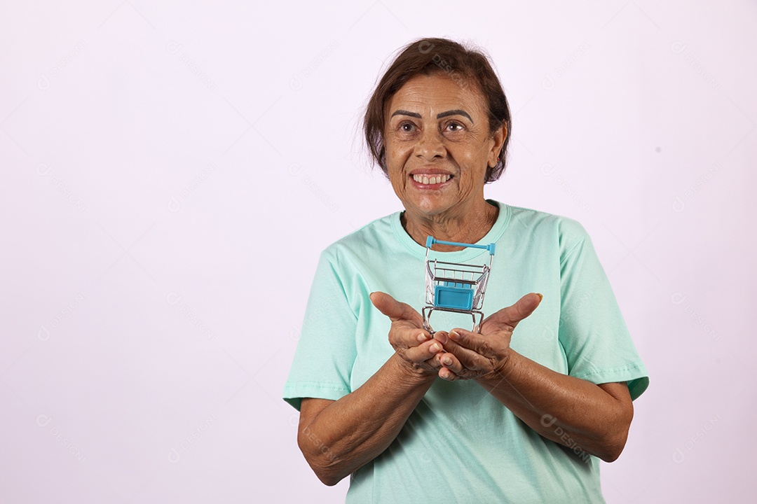 Mulher idosa morena segurando carrinho de compras sobre fundo isolado