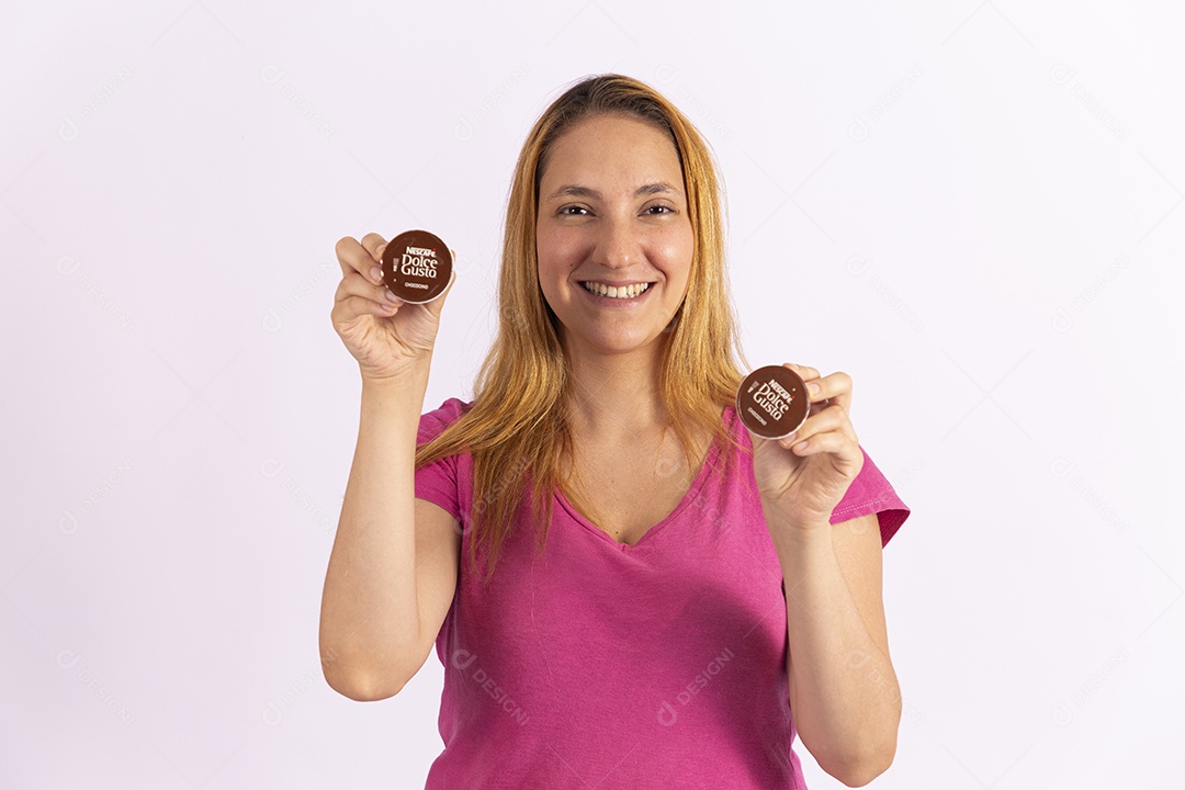 Mulher jovem segurando xícara e capsula de café