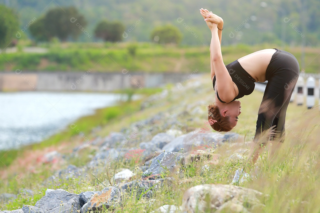 Jovem fazendo exercícios de fitness de ioga Nascer do sol ao ar livre na paisagem de belas montanhas do prado. Meditação e Relax.