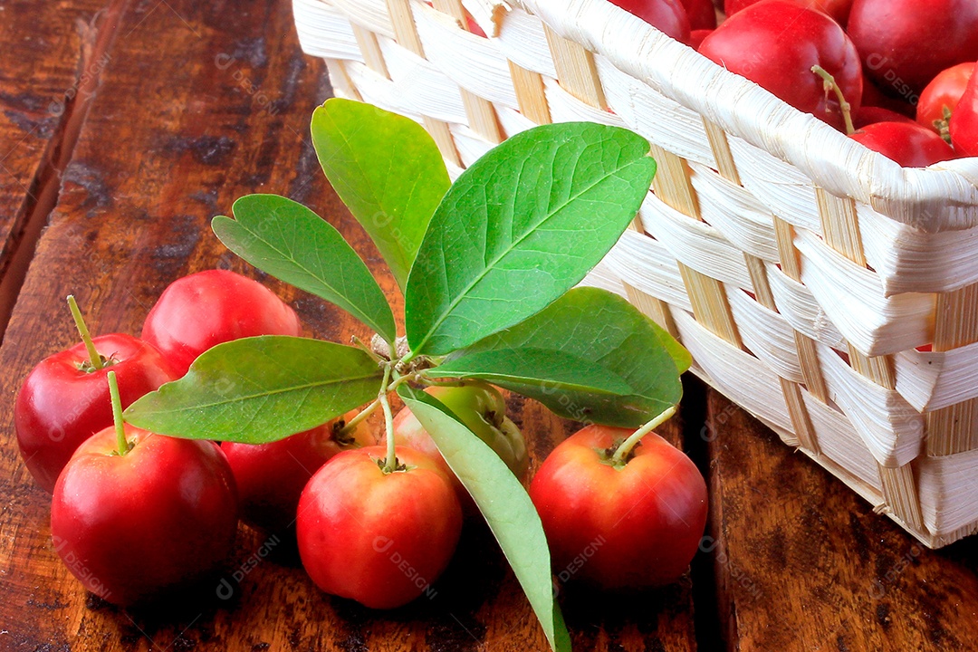 Acerola cereja baga fresca na cesta na mesa de madeira rústica.