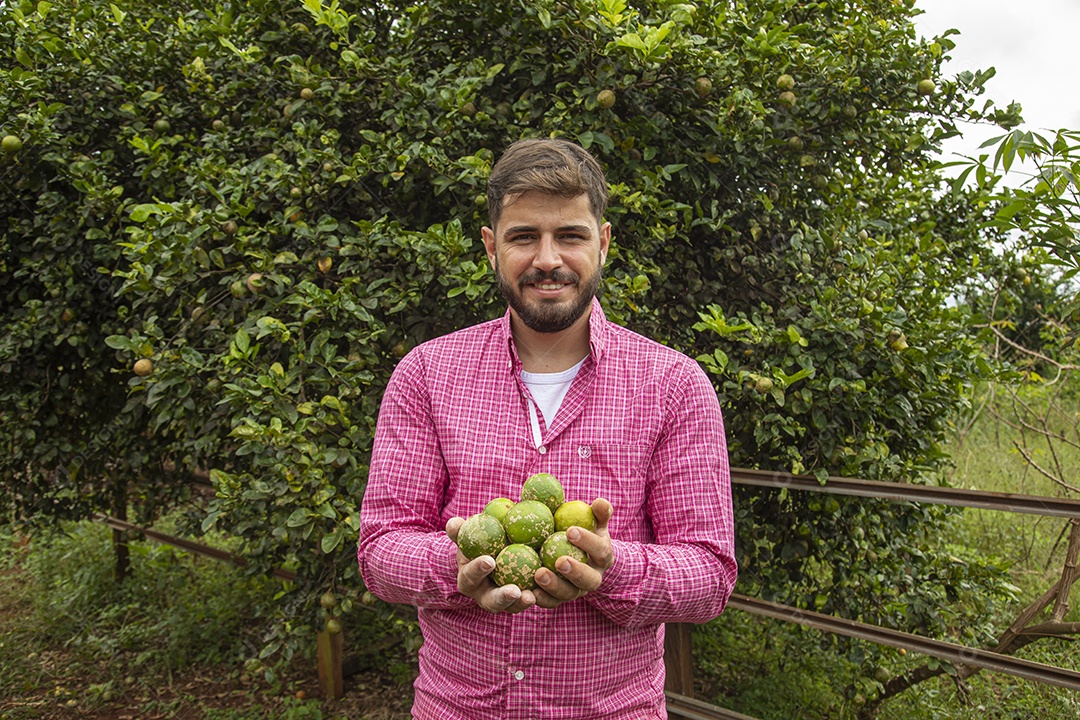 Homem jovem agricultora segurando fruta limão