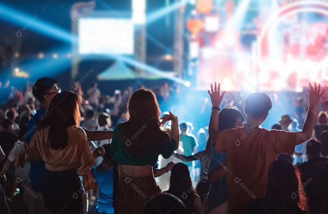 Multidão de mãos levantando as luzes do palco do concerto e a silhueta do público de fãs de pessoas