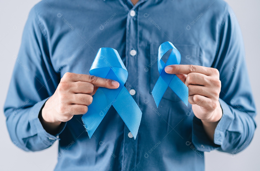 Mãos de homens segurando fita azul para apoiar as pessoas com câncer