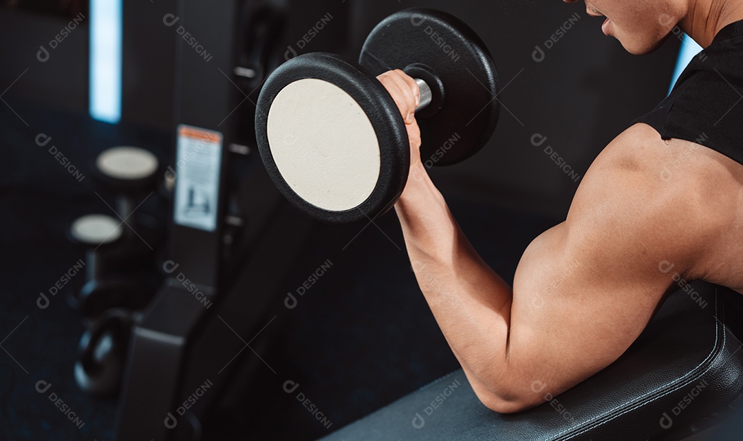 Macho malhando fisiculturista com pesos de halteres no fisiculturista