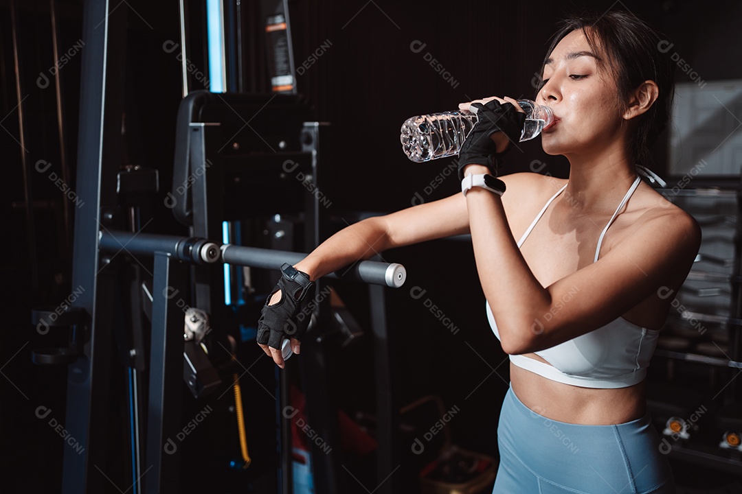 Mulher malhando fisiculturista com pesos de barra na academia.