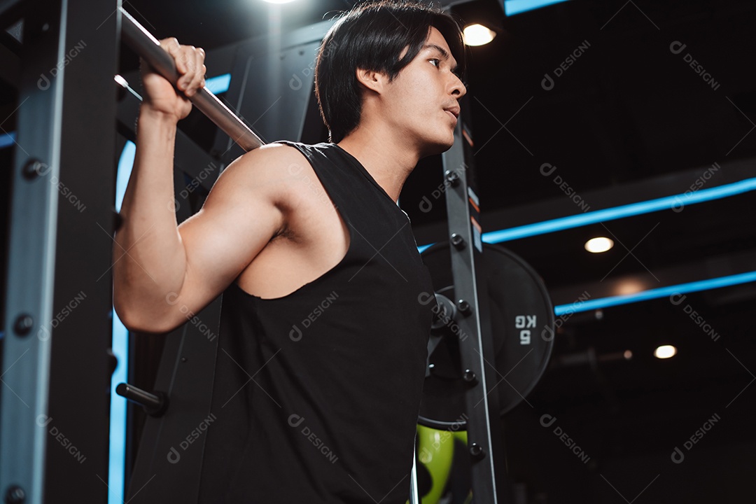 Homem malhando fisiculturista com pesos de barra no ginásio. fisiculturista fazendo exercícios com barra.
