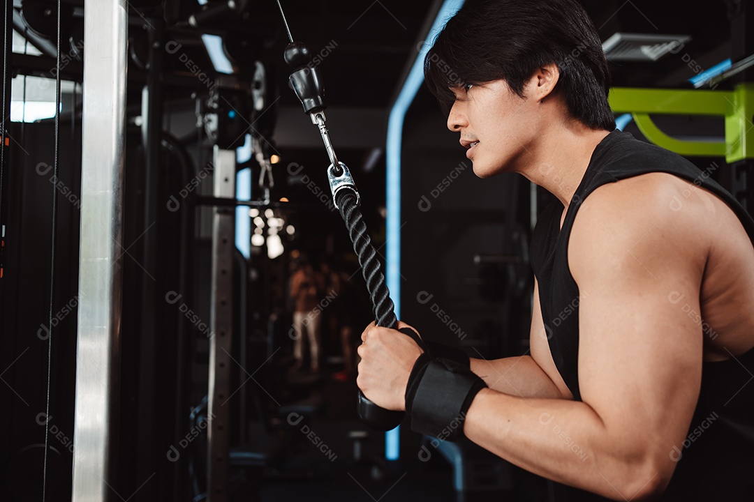 Homem malhando com máquina de treinamento de pesos levantando halteres no ginásio de fitness.