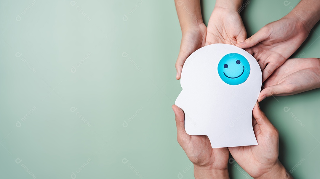 Mãos segurando um rosto sorridente em corte de papel cerebral