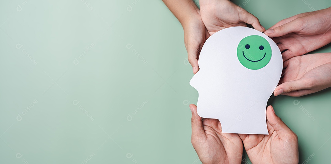 Mãos segurando um rosto sorridente em corte de papel cerebral, emoção sorridente feliz