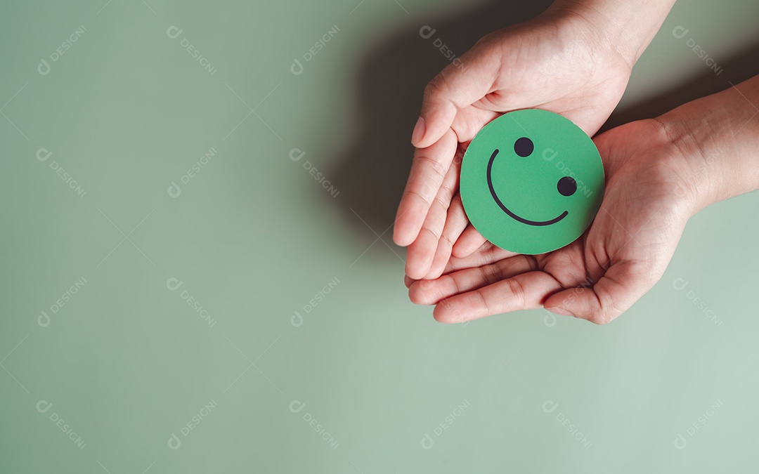 Mãos segurando um sorriso feliz verde, boa classificação de feedback, avaliação positiva do cliente