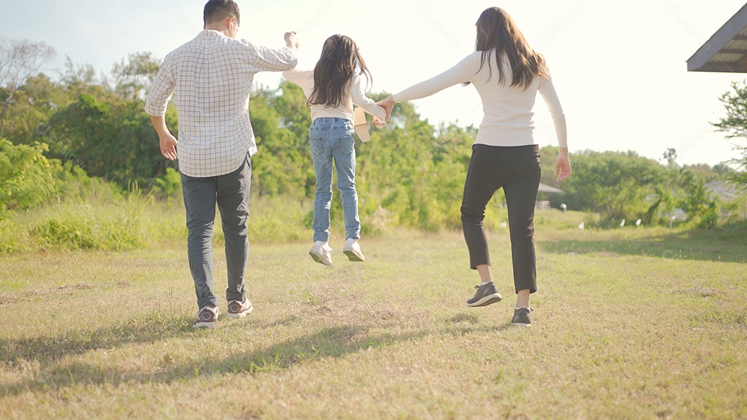 Feliz jovem família asiática caminhando no caminho de mãos dadas com sua filhinha