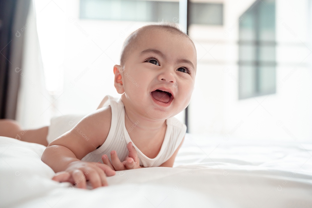 Bebê recém-nascido deitado em uma cama branca em casa.