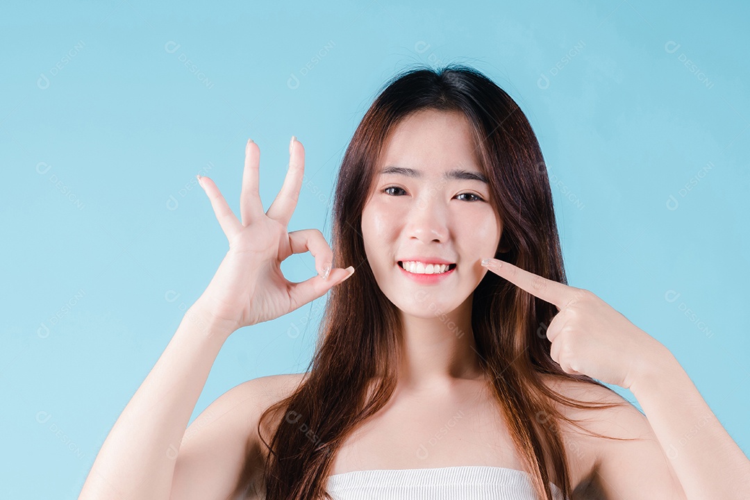 O sorriso da mulher asiática mostra o gesto