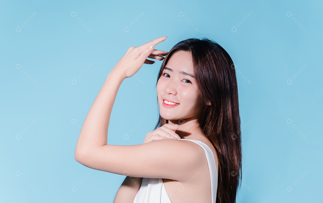 Mulher de beleza asiática encantadora em sessão de fotos com fundo azul