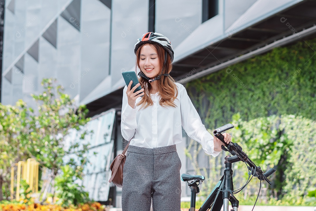 Linda mulher asiática com capacete de segurança andando de bicicleta