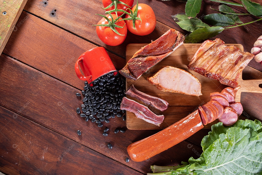 Ingredientes de feijoada sobre uma mesa de madeira
