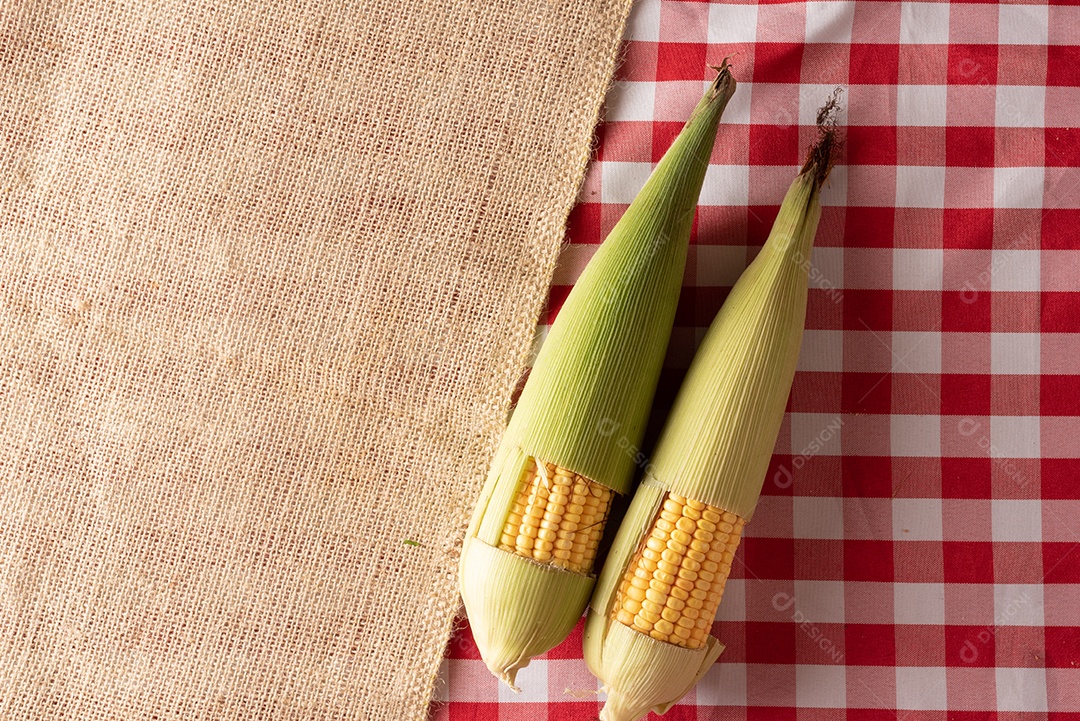 Mesa de madeira com comidas típicas da Festa Junina brasileira. espantalho