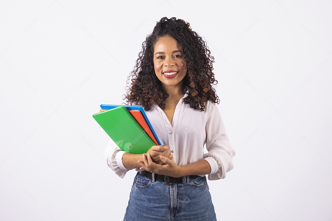 Linda mulher jovem cabelo cacheado segurando material escolar sobre fundo isolado