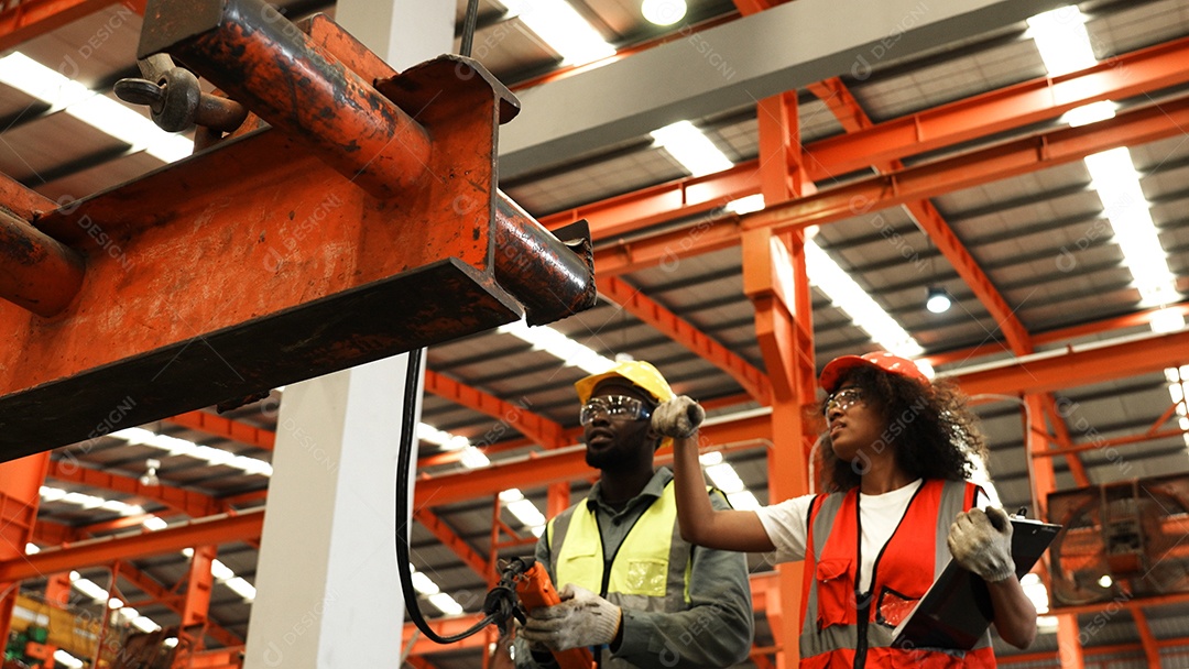 Engenheiros industriais pesados ​​verificam juntos em uma fábrica de aço.