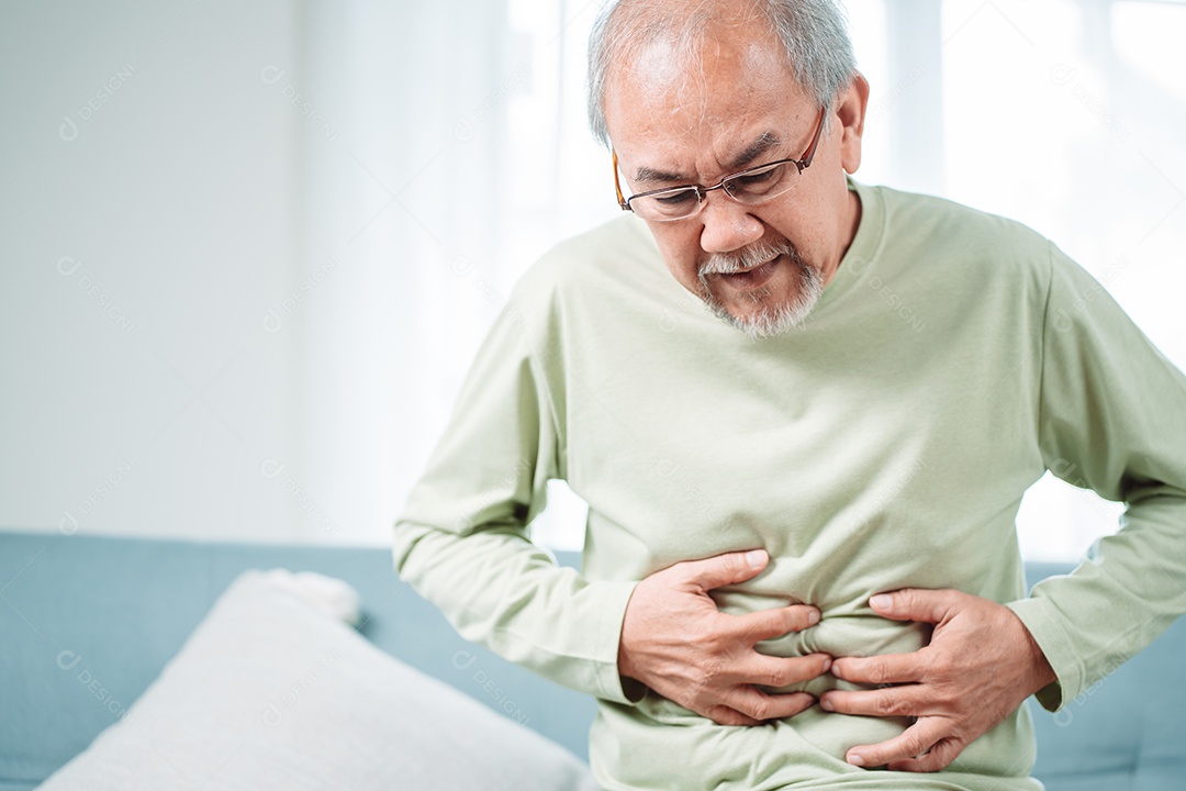 Homem sênior asiático sente dor de estômago.